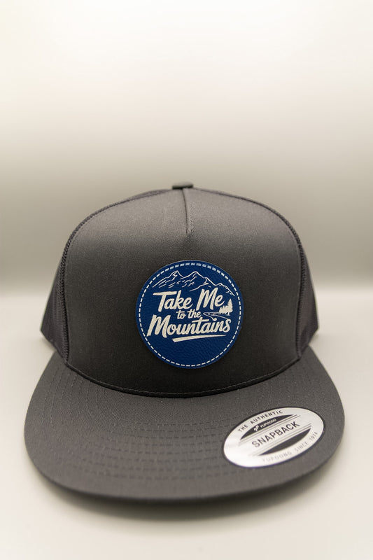 Take Me to the Mountains Blue White Patch Charcoal Flat Trucker Cap