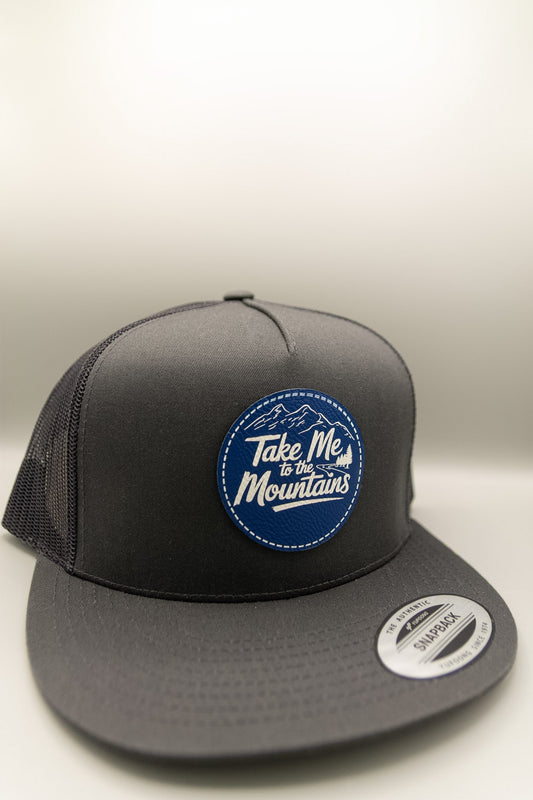 Take Me to the Mountains Blue White Patch Charcoal Flat Trucker Cap