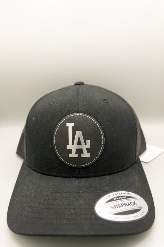 LA Black Silver Patch Black Curve Trucker Cap