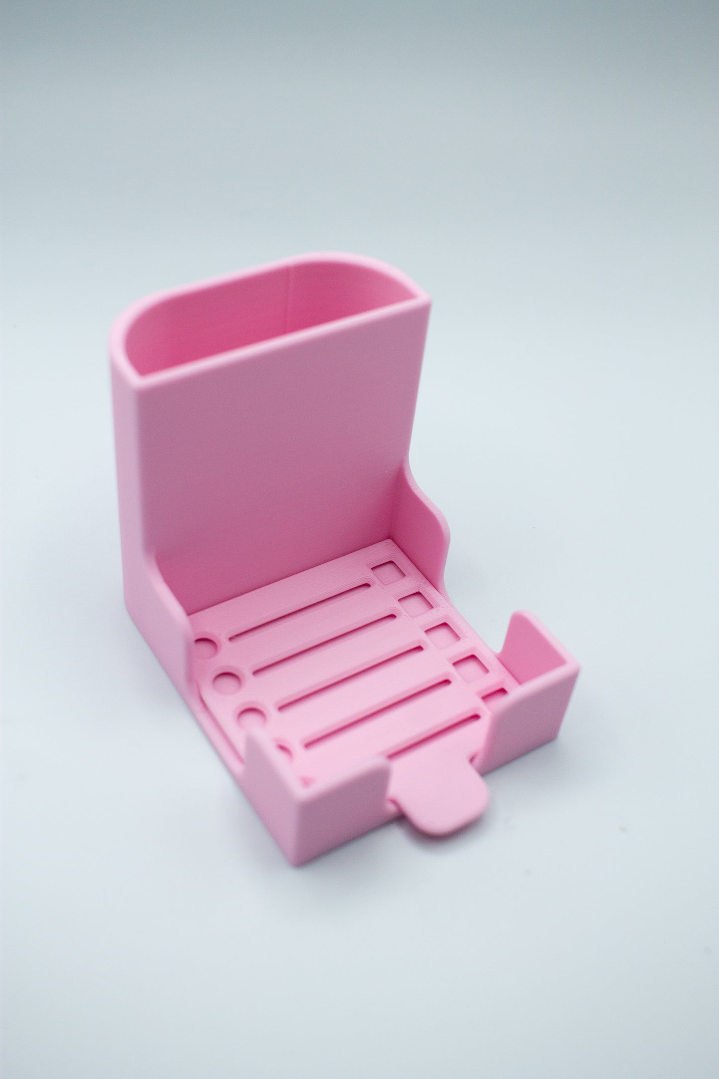 Pink post-it holder with to-do list stencil on a light gray background
