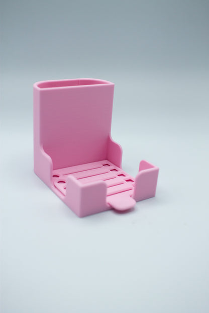 Pink post-it holder with to-do list stencil on a light gray background