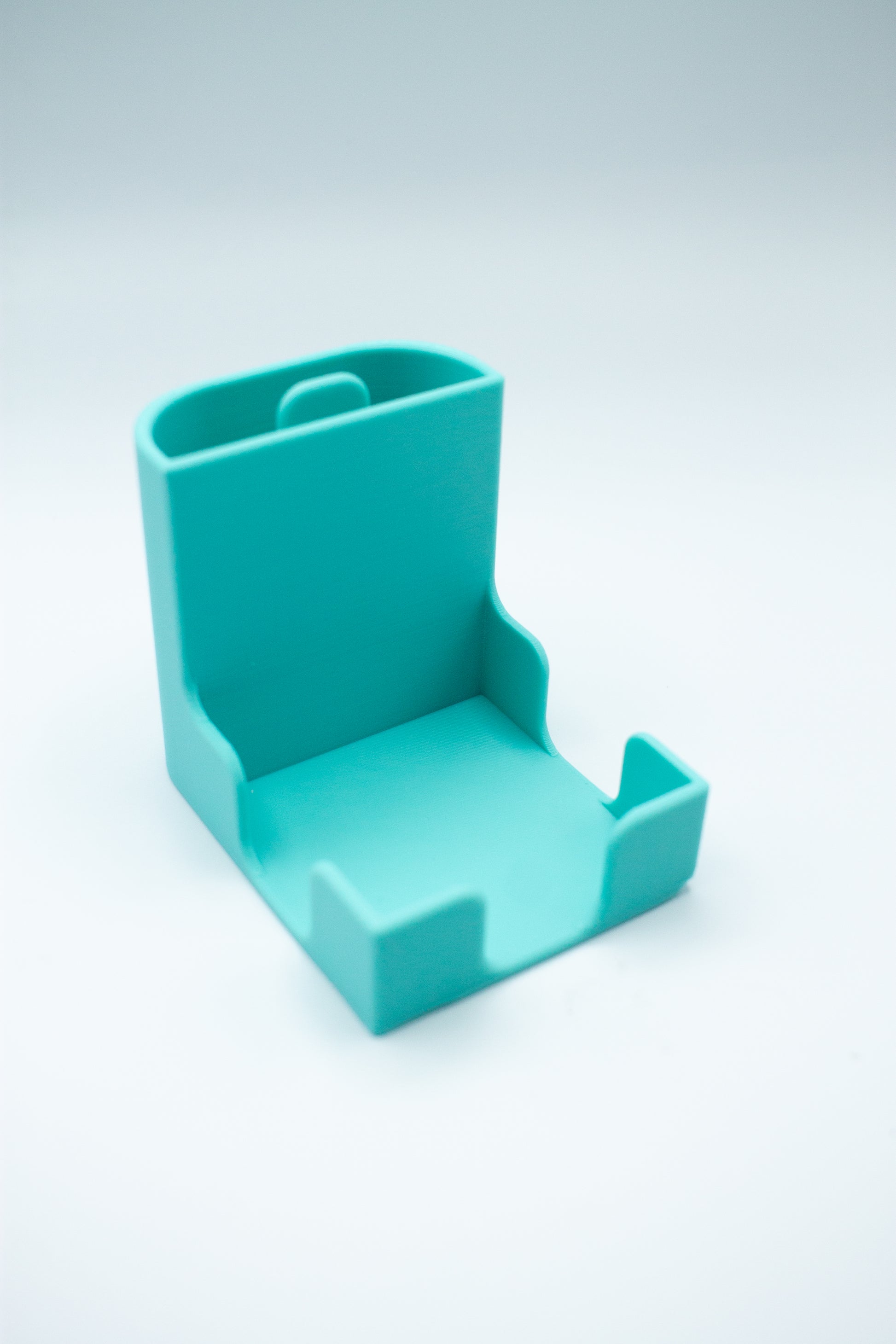 turquoise post-it holder with to-do list stencil on a light gray background