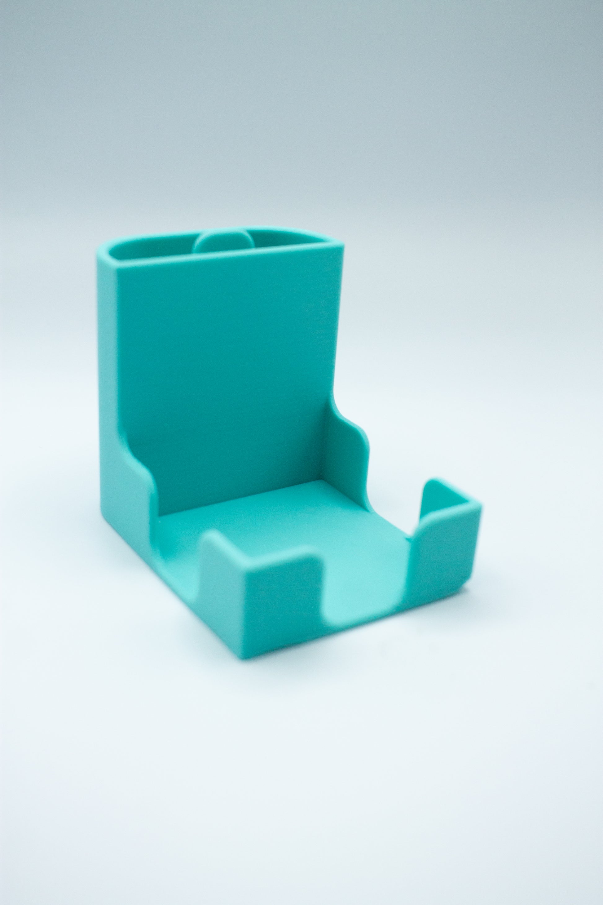 Turquoise post-it holder on a white background