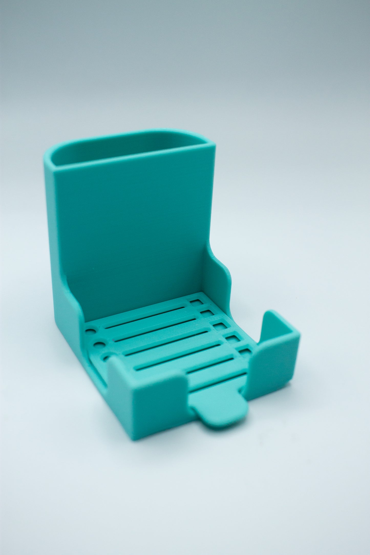 turquoise post-it holder with to-do list stencil on a light gray background