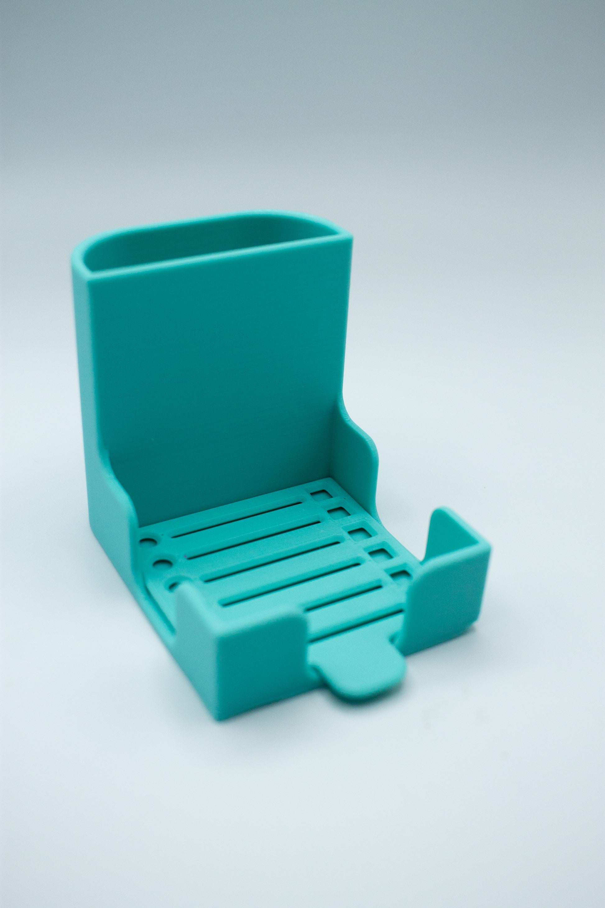 turquoise post-it holder with to-do list stencil on a light gray background