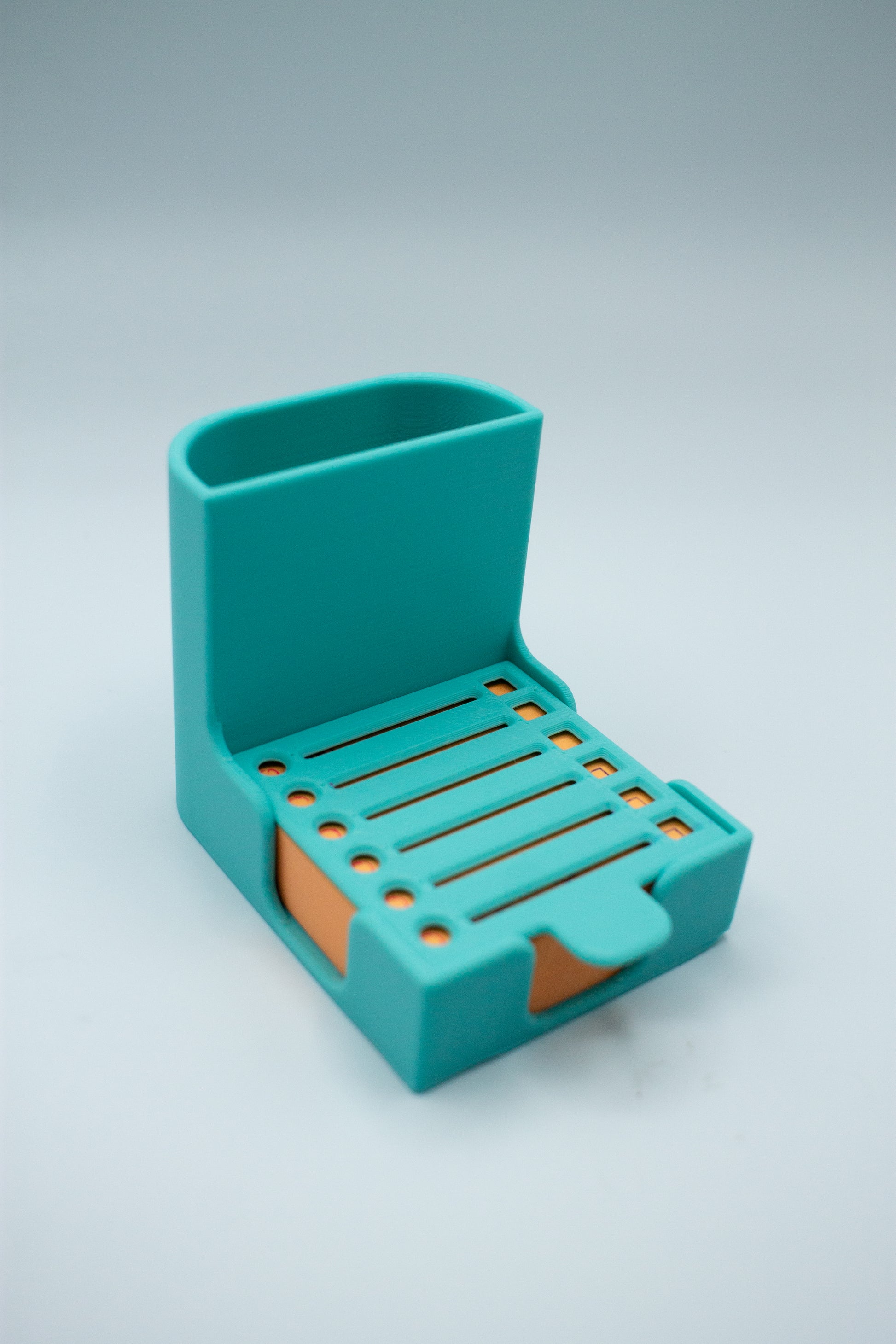 turquoise teal post-it holder with to-do list stencil on a light gray background