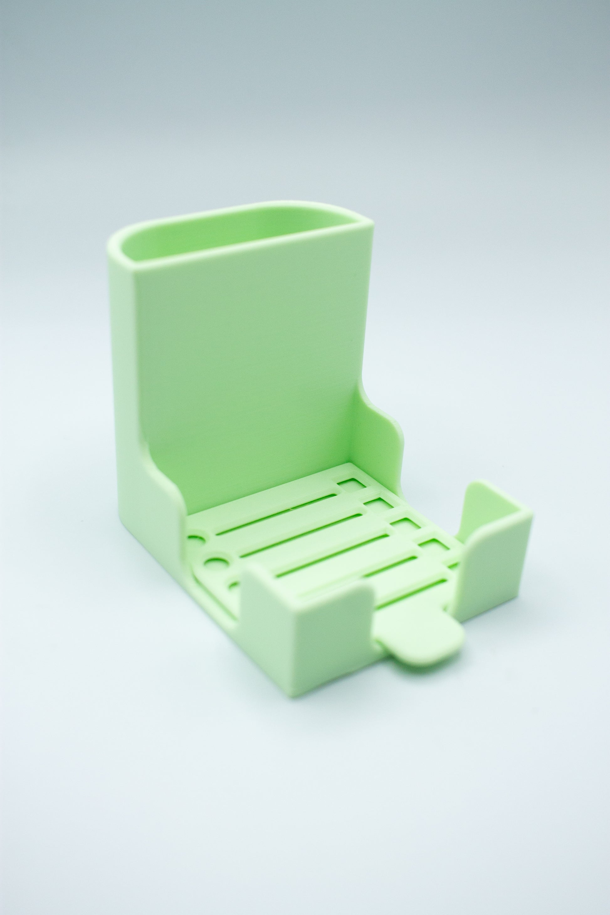 Light green post-it holder with to-do list stencil on a light gray background