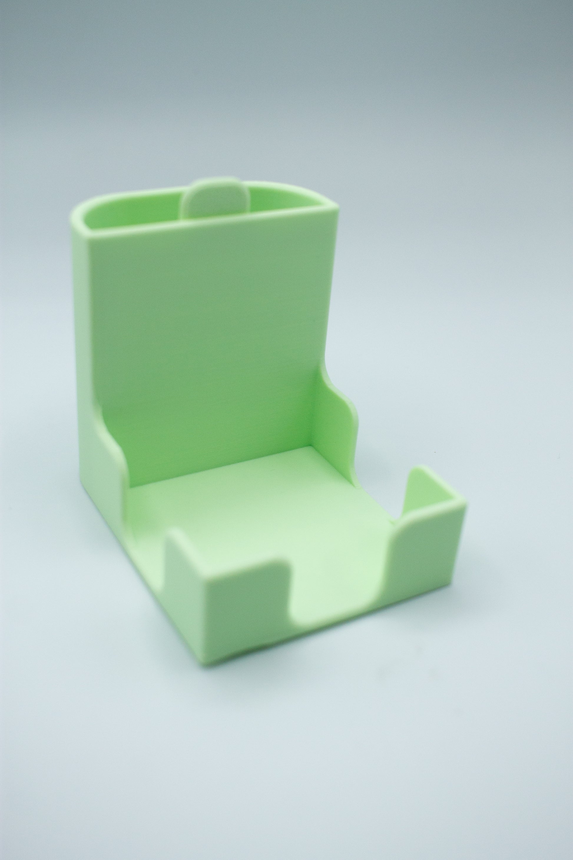 mint green post-it holder with to-do list stencil on a light gray background